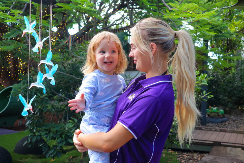 Hummingbird House staff holding child